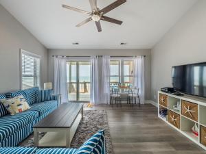 a living room with a couch and a flat screen tv at HypNautical in Surf City