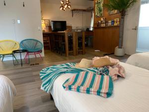 a bedroom with a bed with towels on it at HAMBY101 in Chatan
