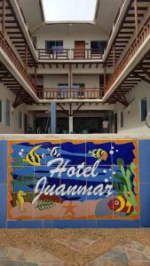 a banner on a wall in front of a building at Hotel Juanmar in Juan de Acosta
