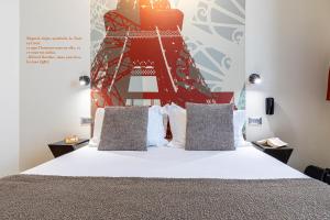 a bedroom with a bed with a red and white headboard at Hotel Alpha Paris Eiffel by Patrick Hayat in Boulogne-Billancourt