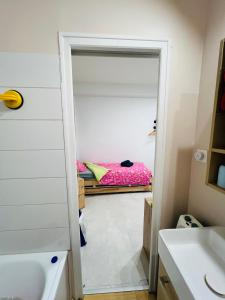 a bathroom with a closet with a bed in the background at La fabrica deu rei Enric in Pau