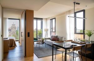 a living room with a couch and a table at Archie Living in Barcelona