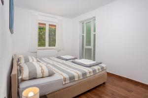 Łóżko lub łóżka w pokoju w obiekcie Apartments Villa Temer