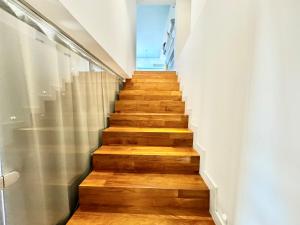 a staircase with wooden floors and white walls at La Gaetana in Gaeta