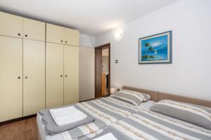 Łóżko lub łóżka w pokoju w obiekcie Apartments Villa Temer