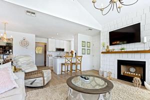 a living room with a couch and a fireplace at Beachside Elegance: Pool Spa Luxury Retreat Sun Beach Club 888 in Edgewater