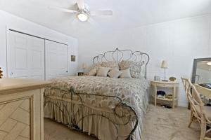 a bedroom with a bed and a ceiling fan at Beachside Elegance: Pool Spa Luxury Retreat Sun Beach Club 888 in Edgewater +30 photos