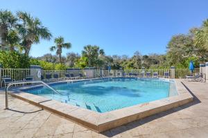 a large swimming pool with chairs around it at Beachside Elegance: Pool Spa Luxury Retreat Sun Beach Club 888 in Edgewater
