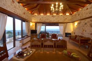 a large living room with a chandelier and a living room at Dream Hill Villas in Tavronitis