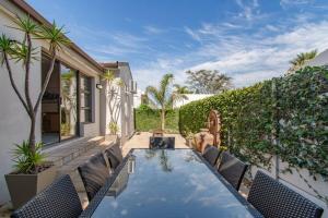 a backyard with a swimming pool and chairs at Chic, Cozy, Modern, Secure and Centrally Located in Cape Town