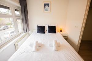 a white bed in a room with a window at Amazing 50m2 Two-Bedroom Apartment - TS307A in Eindhoven