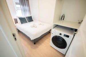 a small room with a bed and a washing machine at Amazing 50m2 Two-Bedroom Apartment - TS307A in Eindhoven