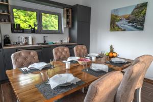 a dining room with a wooden table and chairs at Japods Kingdom in Bihać