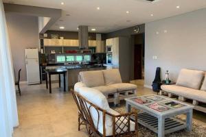a living room with two couches and a table at CASA VIVE, EL MEJOR PAISAJE De SALTA in Salta