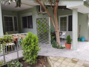 a house with a patio with a gate and plants at Vila Katerina Dojran in Sretenovo +2 photos