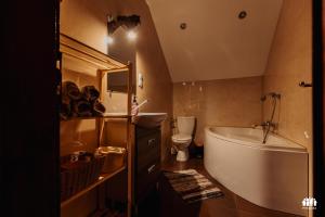 a bathroom with a tub and a sink and a toilet at Puszcza - Przestrzeń Kreatywna in Andrzejów +29 photos