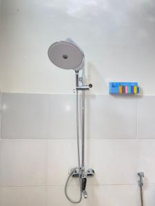 a shower with a shower head in a bathroom at Efrata Villa in Gili Islands