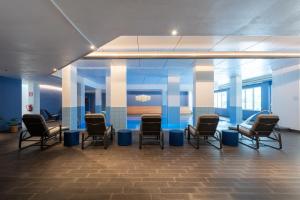 a waiting room with chairs and a table at Ai Pozzi Village Resort & SPA in Loano