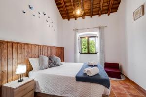 a bedroom with a large bed and a window at Casa da Ti Inácia - Praia Azenhas D El Rey in Montes Juntos +23 photos