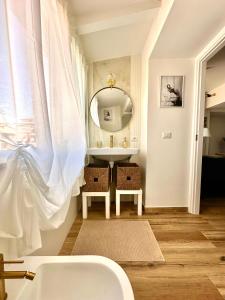 a bathroom with a sink and a mirror at Domus Traiano - Port Apartment in Civitavecchia
