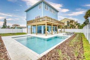 a house with a swimming pool in front of a house at Ocean River View Pool Home Close to Amenities 6635T in New Smyrna Beach
