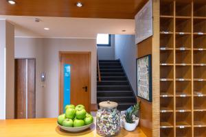 a room with a staircase and a bowl of apples at Hotel Diana in Lido di Jesolo