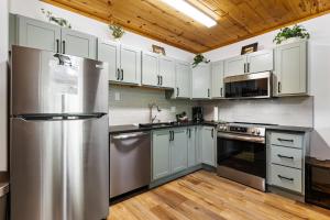 une cuisine avec des appareils en acier inoxydable et des armoires blanches dans l'établissement Bugle Pointe B12 by Estes Park Condos, à Estes Park 12 autres photos