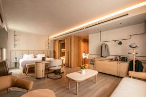 a hotel room with a bed and a kitchen at Only YOU Hotel Málaga in Málaga