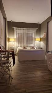 a large bedroom with a large bed and a table at Il Mare Di Roma Luxury in Lido di Ostia