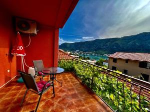 a balcony with a table and chairs and a view at Apartments Lazarević in Kotor