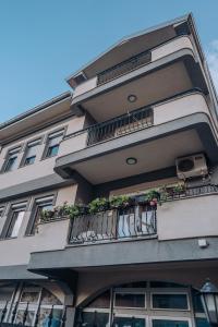 a building with a balcony with flowers on it at Bisera Apartments in Ohrid