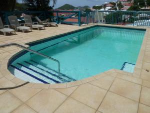 a swimming pool with a stair in the middle at Galleon House Hotel in Charlotte Amalie