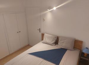 a bedroom with a bed with white sheets and pillows at Lumbarda, Korcula apartment near the beach in Lumbarda