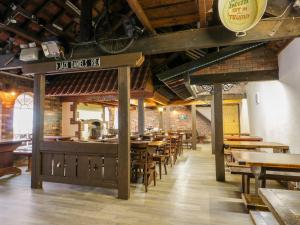 a restaurant with tables and chairs and a bike on the ceiling at Lupin Cottage in Filey