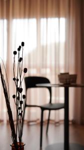 a table and a chair in a living room at Binario9 in Lecce
