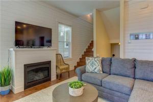 a living room with a couch and a fireplace at Spindrift by Seabrook Hospitality in Pacific Beach