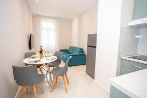 a kitchen and dining room with a table and chairs at Apartment Kjara in Herceg-Novi