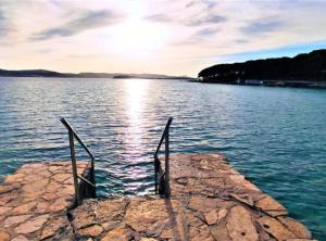 a dock in the middle of a large body of water at Mobile Home Nensi in Biograd na Moru