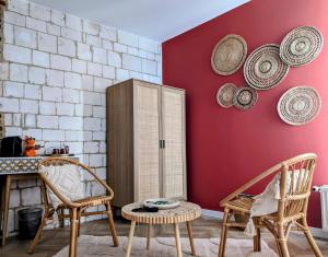 a room with chairs and a cabinet with hats on the wall at Le Relais du Beffroi & SPA in Saint-Riquier
