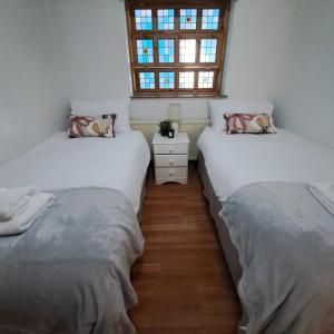 Ένα ή περισσότερα κρεβάτια σε δωμάτιο στο Cute little 2 bed near Cambridge