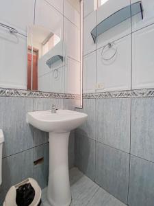 uma casa de banho com um lavatório branco e um espelho. em Hotel Presidencial em Chiclayo