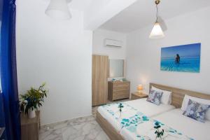 a living room with a bed and a couch at Ammos Beach Apartment in Skaleta
