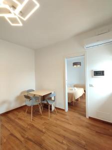 a room with a table and chairs and a bed at Ravanas 33 in Bari