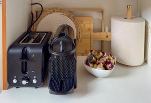a kitchen counter with a toaster and a bowl of food at Le Saint Lazare in Compiègne