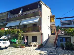 a building with stairs and a table and chairs at More in Crikvenica