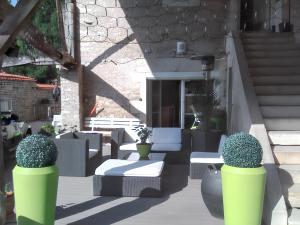 a patio with chairs and potted plants and stairs at Appartement de 2 chambres avec terrasse amenagee et wifi a Chenevrey et Morogne in Chenevrey-et-Morogne