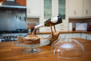 a bottle of wine being poured into a piece of cake at Spacious River View Retreat Near Peak District in Matlock +53 photos