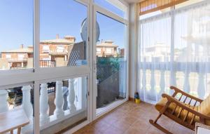 a room with a balcony with a chair and a window at 2 Bedroom Beautiful Home In Castalla in Castalla