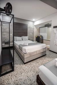 1 dormitorio con 1 cama grande y espejo en Mándala Botero Medellín en Medellín