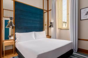 Cama ou camas em um quarto em Room Mate Luca, Florence